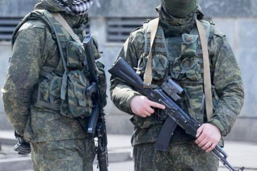 
Armed men stood guard Saturday in Simferopol, Ukraine. Soldiers wore uniforms with no...