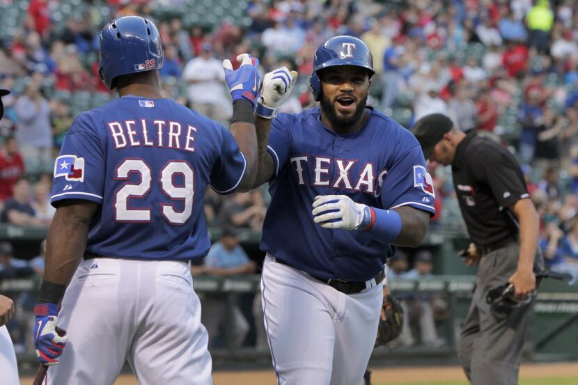 Texas Rangers first baseman Prince Fielder (84) is met at the plate by Texas Rangers third...