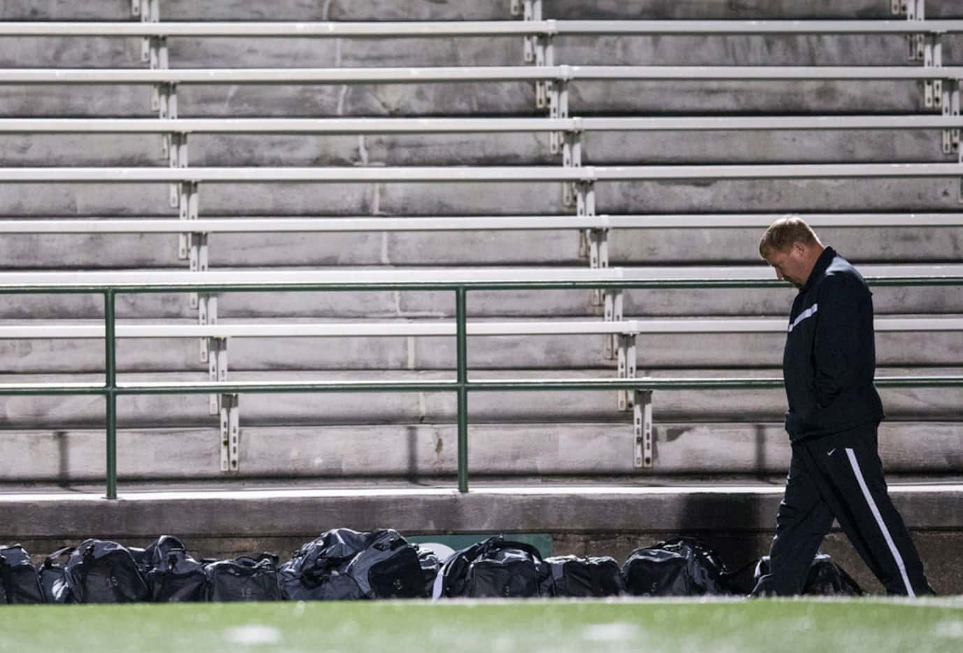Forney soccer coach Kris Duplissey walks along the sideline during halftime of a game...