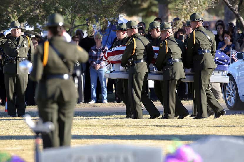 Border Patrol pallbearers carry Border Patrol agent Rogelio Martinez to a graveside service...