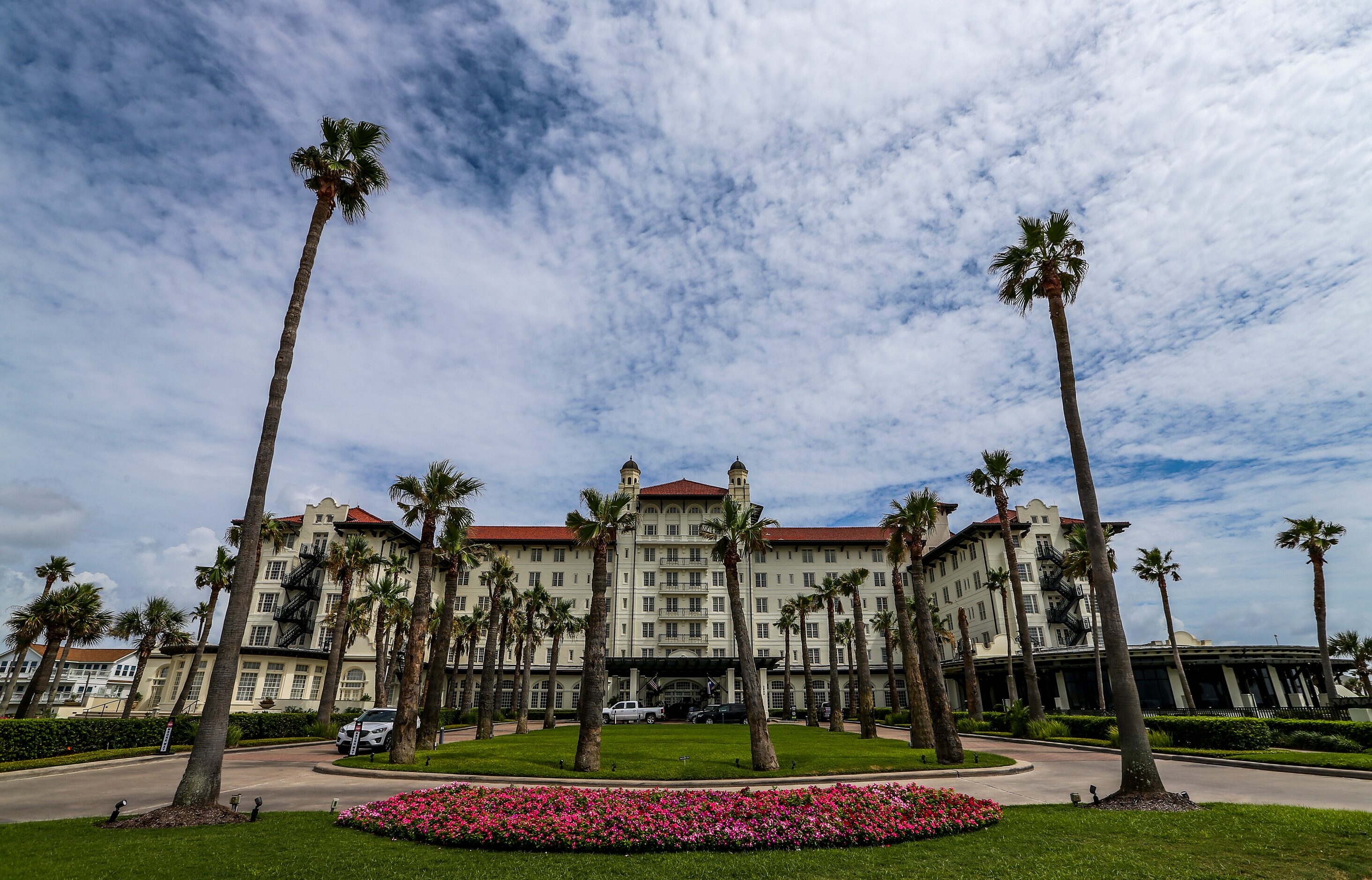 Painters work on the outside of the Grand Galvez hotel on July 15 in Galveston.