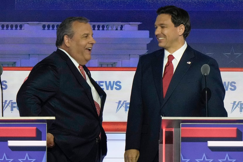 Former New Jersey Gov. Chris Christie talks with Florida Gov. Ron DeSantis during a break in...