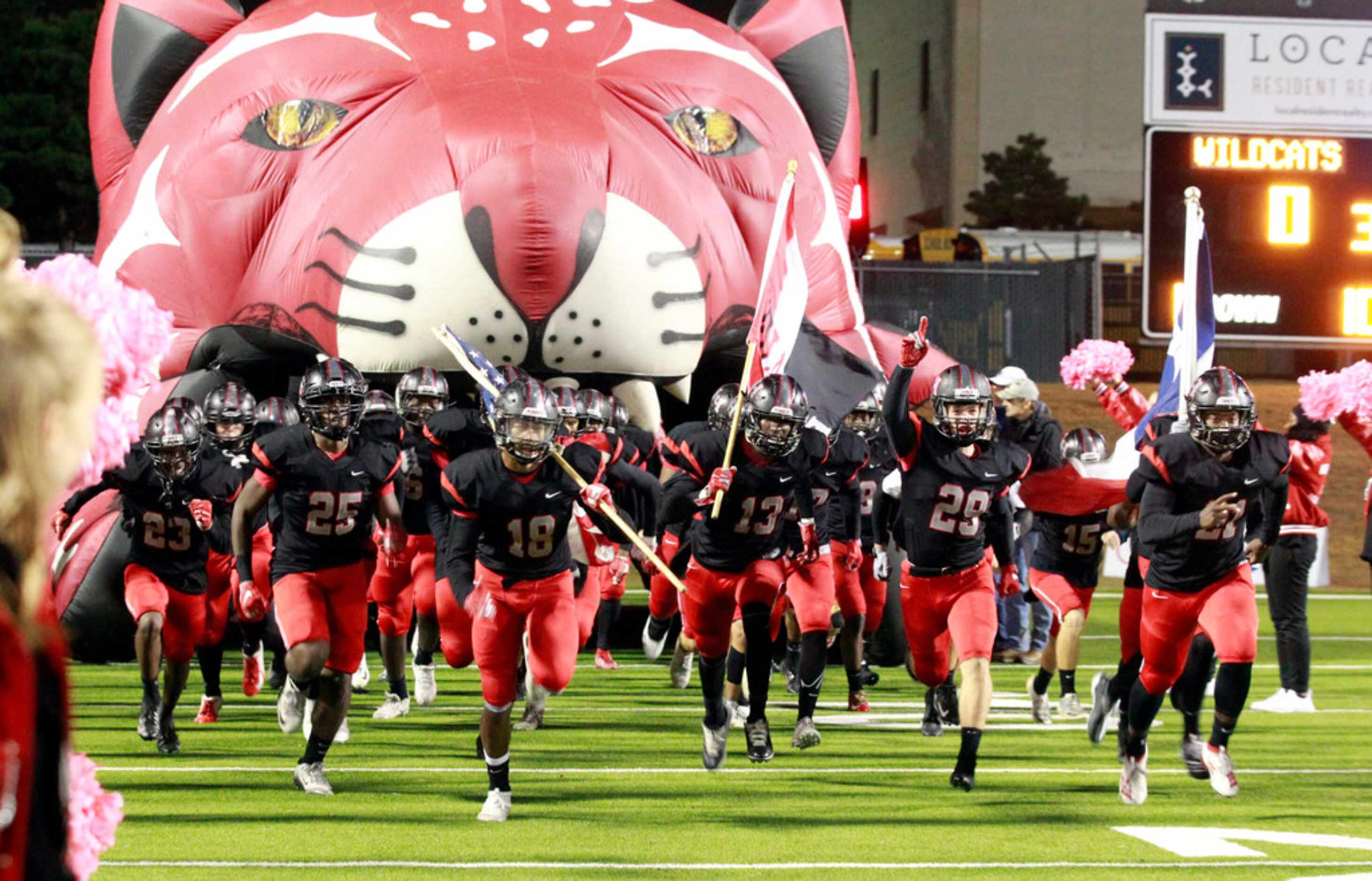 The Lake Highlands team takes the field before the start of their high school football game...