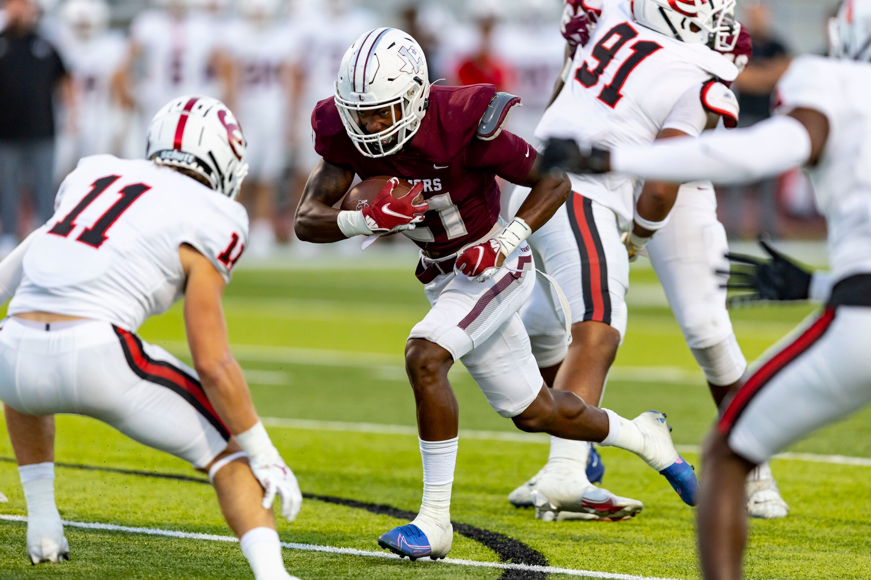 Lewisville junior running back Viron Ellison (21) carries the ball as Coppell sophomore...