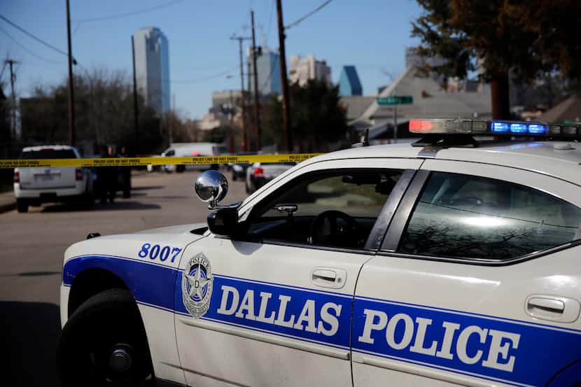 Crime scene tape crosses Browder St. as Dallas police officers investigate the scene of a...