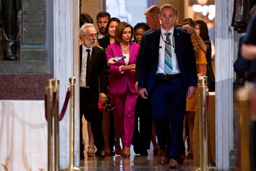 US speaker of the House, Nancy Pelosi (C) walks with reporters, before the Democrat...