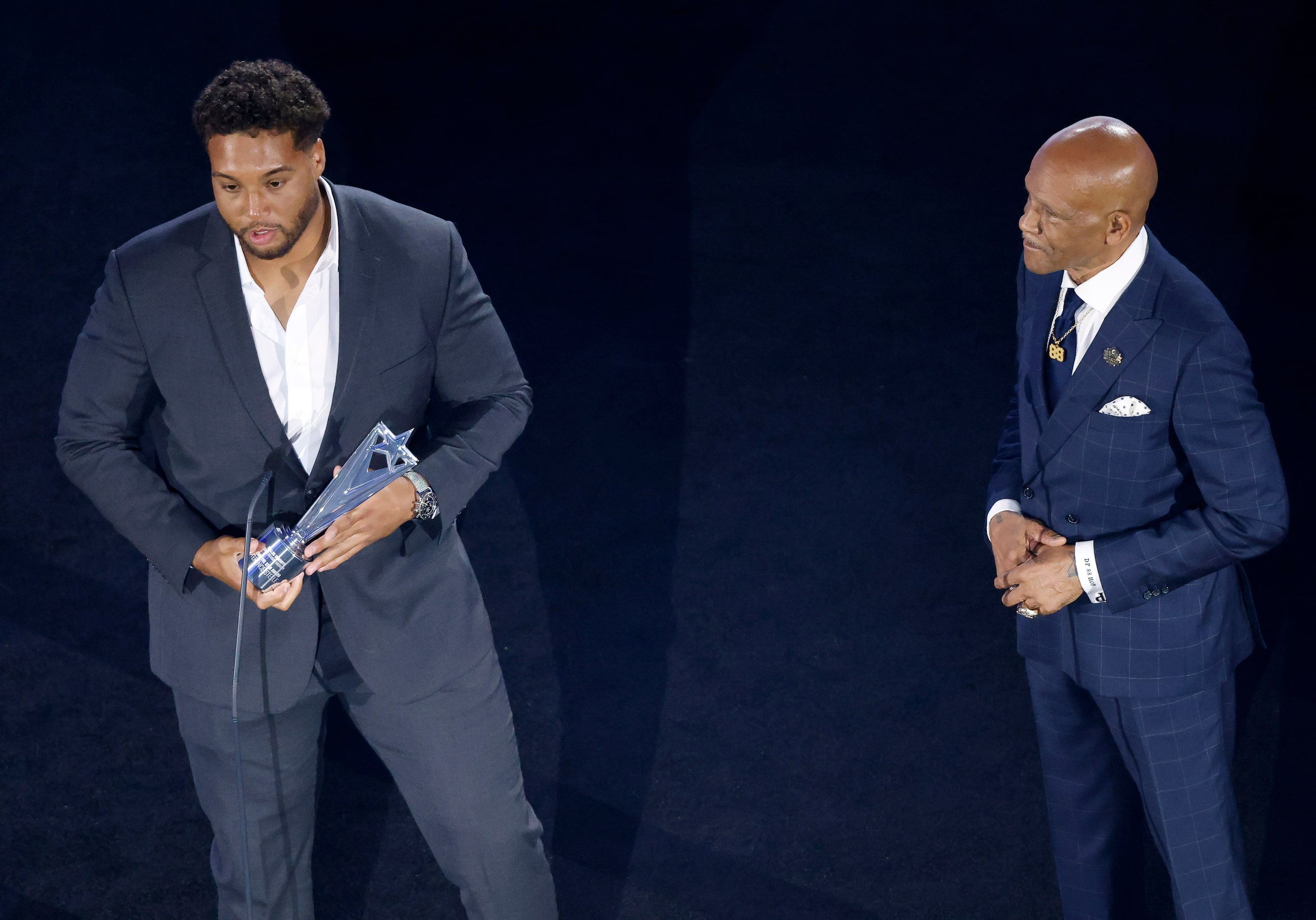 Former Dallas Cowboys Hall of Famer Drew Pearson (right) listens to Cowboys offensive tackle...