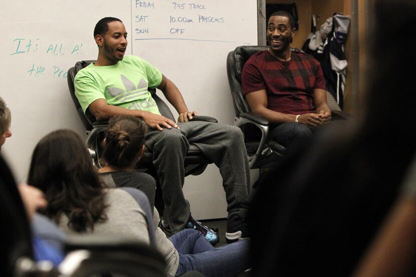 Dallas Mavericks players Devin Harris and Wayne Ellington talk with fans in the team's...