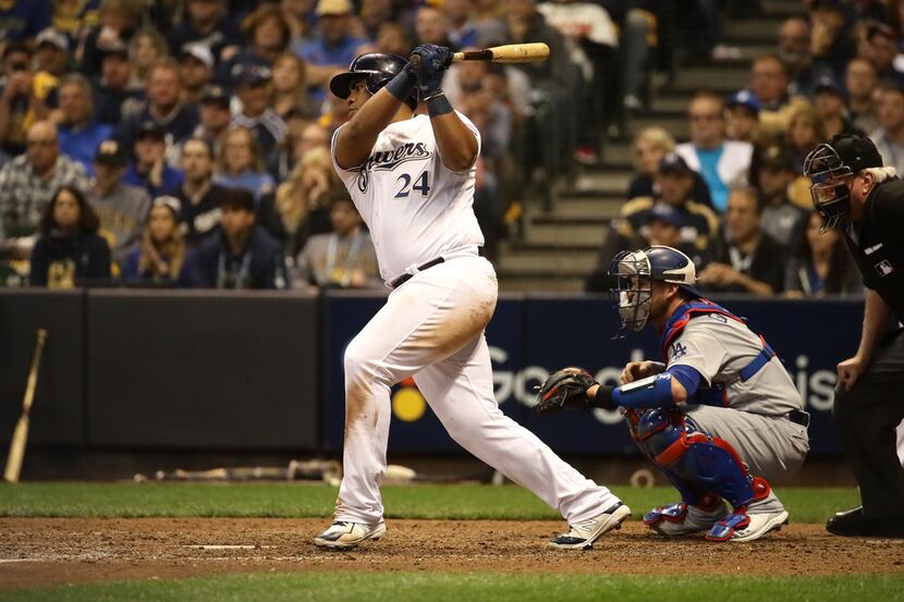 MILWAUKEE, WI - OCTOBER 19:  Jesus Aguilar #24 of the Milwaukee Brewers hits an RBI single...