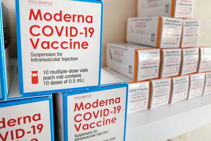 Used boxes of Moderna and Pfizer-BioTech COVID-19 vaccines are on display at a Hurst...