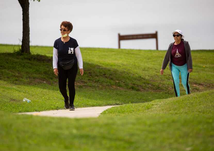 Christina Martinez (left) walked with neighbor and friend Teresa Rodriguez at Bachman Lake...