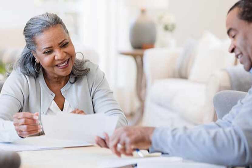 lady and man look over financial papers