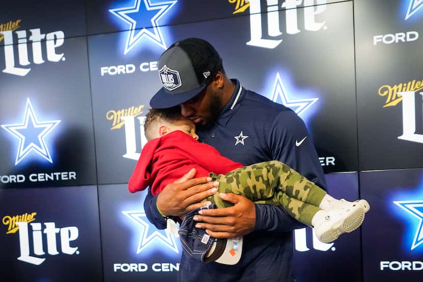 Dallas Cowboys first-round draft pick Micah Parsons held his sleeping son, Malcolm, 3, after...