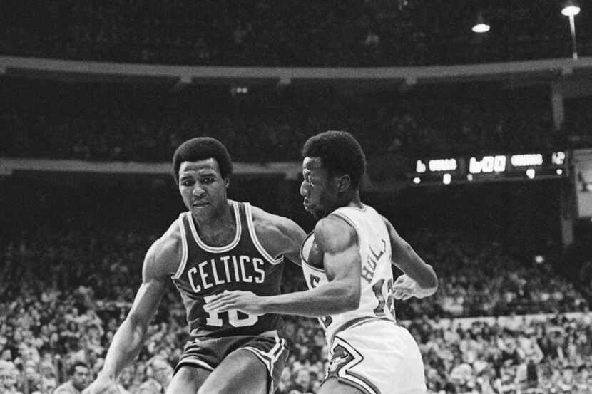 In this Dec. 30, 1977 file photo, Jo Jo White, left, of Boston Celtics, drives past Chicago...