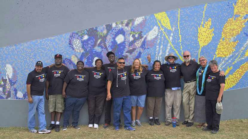 A group of ex-offenders and city of Grand Prairie staffers and volunteers pose in front of...