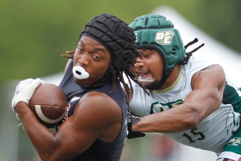 DeSoto defender Brandon Booker (15), right, leaps to stop a Katy Tomkins receiver following...