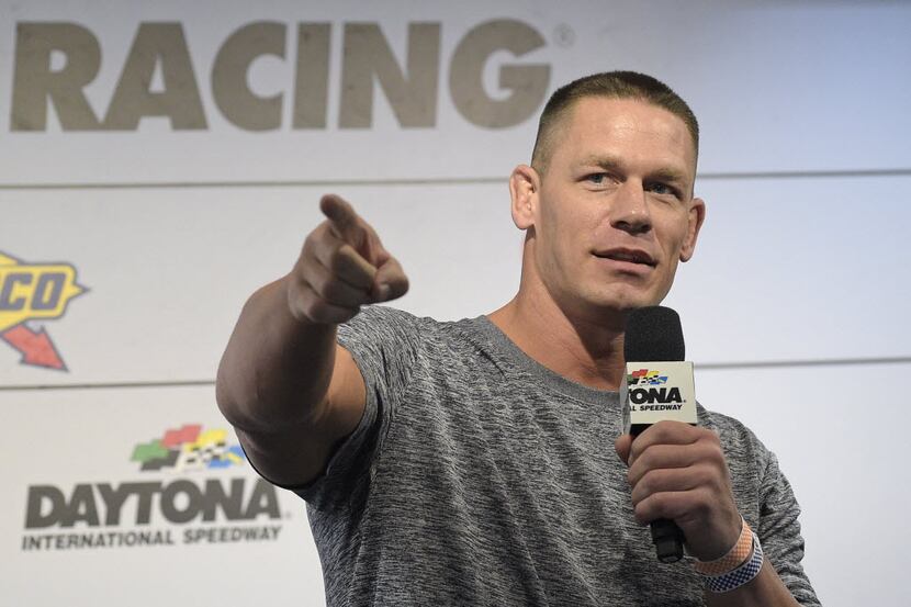 Professional wrestler John Cena answers question from the media during a news conference...