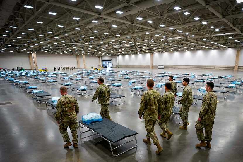 Members of the Texas Army National Guard set up a field hospital at the Kay Bailey Hutchison...