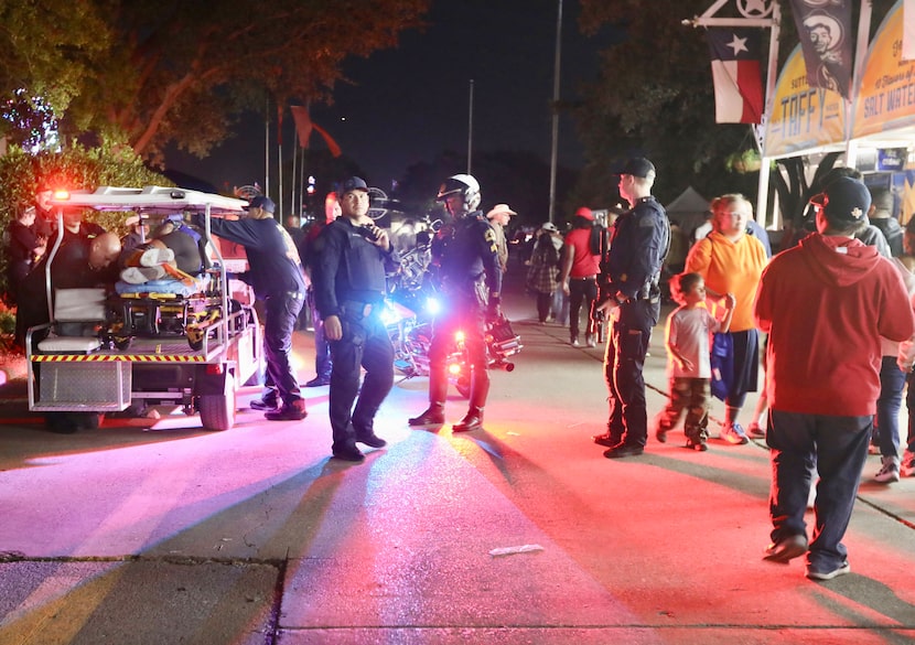 Dallas Fire-Rescue EMS loads one of the wounded onto a cart after a shooting at the State...