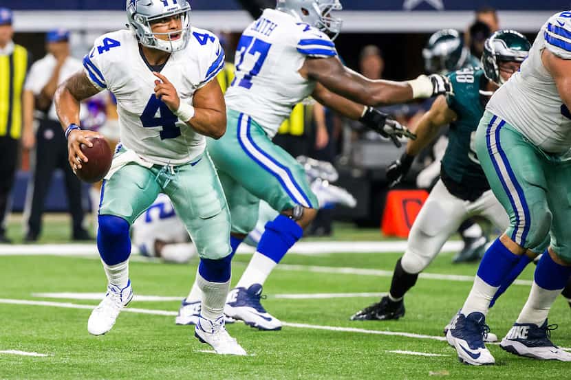 Dallas Cowboys quarterback Dak Prescott (4) scrambles away from the Philadelphia Eagles...