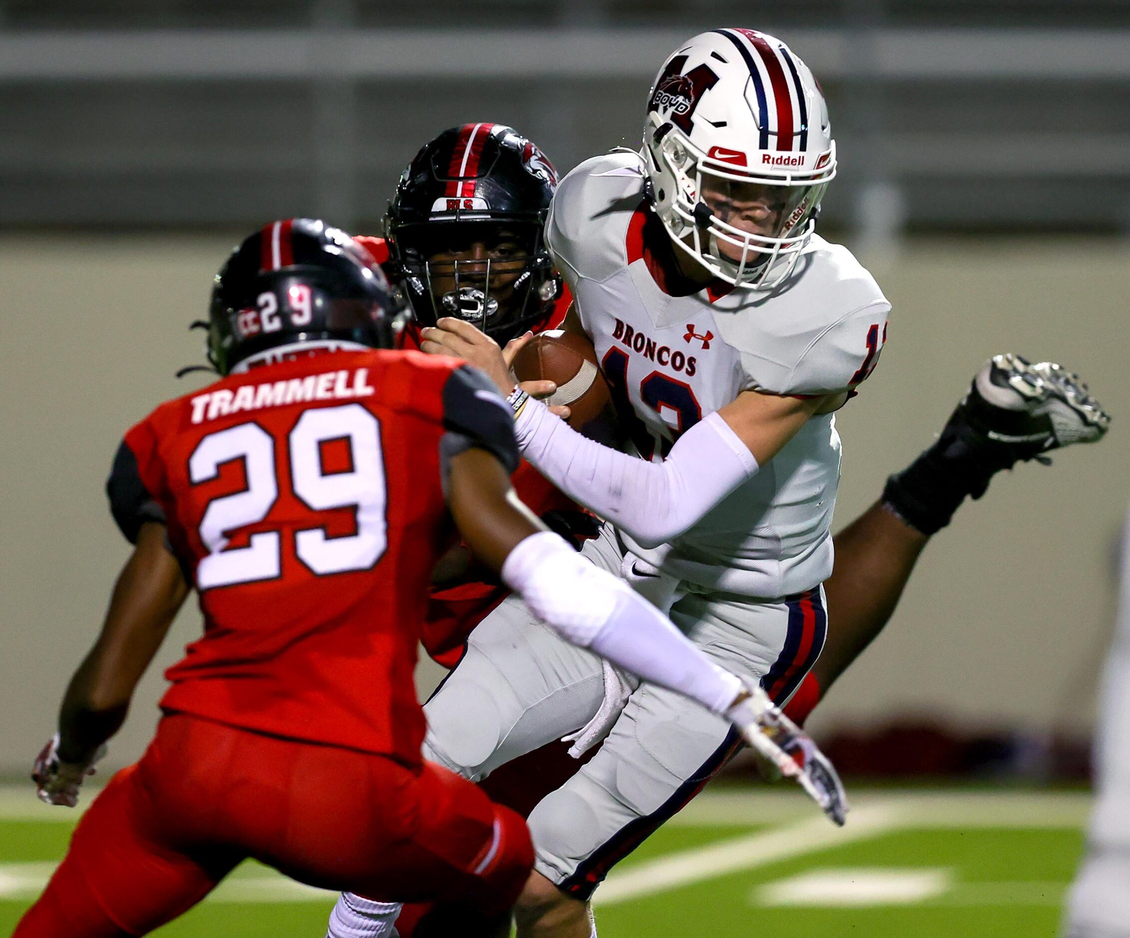 McKinney Boyd quarterback Ryan Shackleton (13) tries to avoid a sack from Denton Braswell...