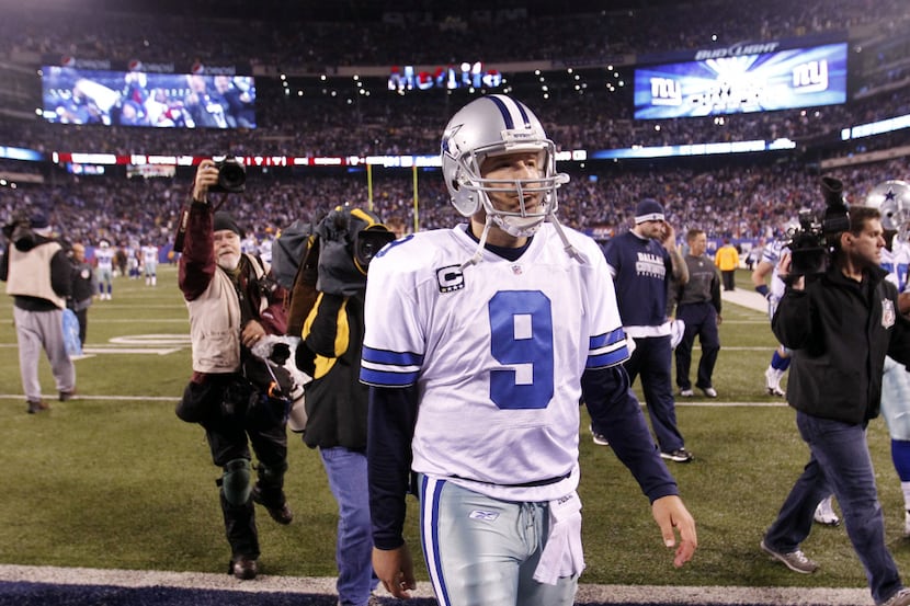 Dallas Cowboys quarterback Tony Romo (9) walks off the field after losing to the New York...