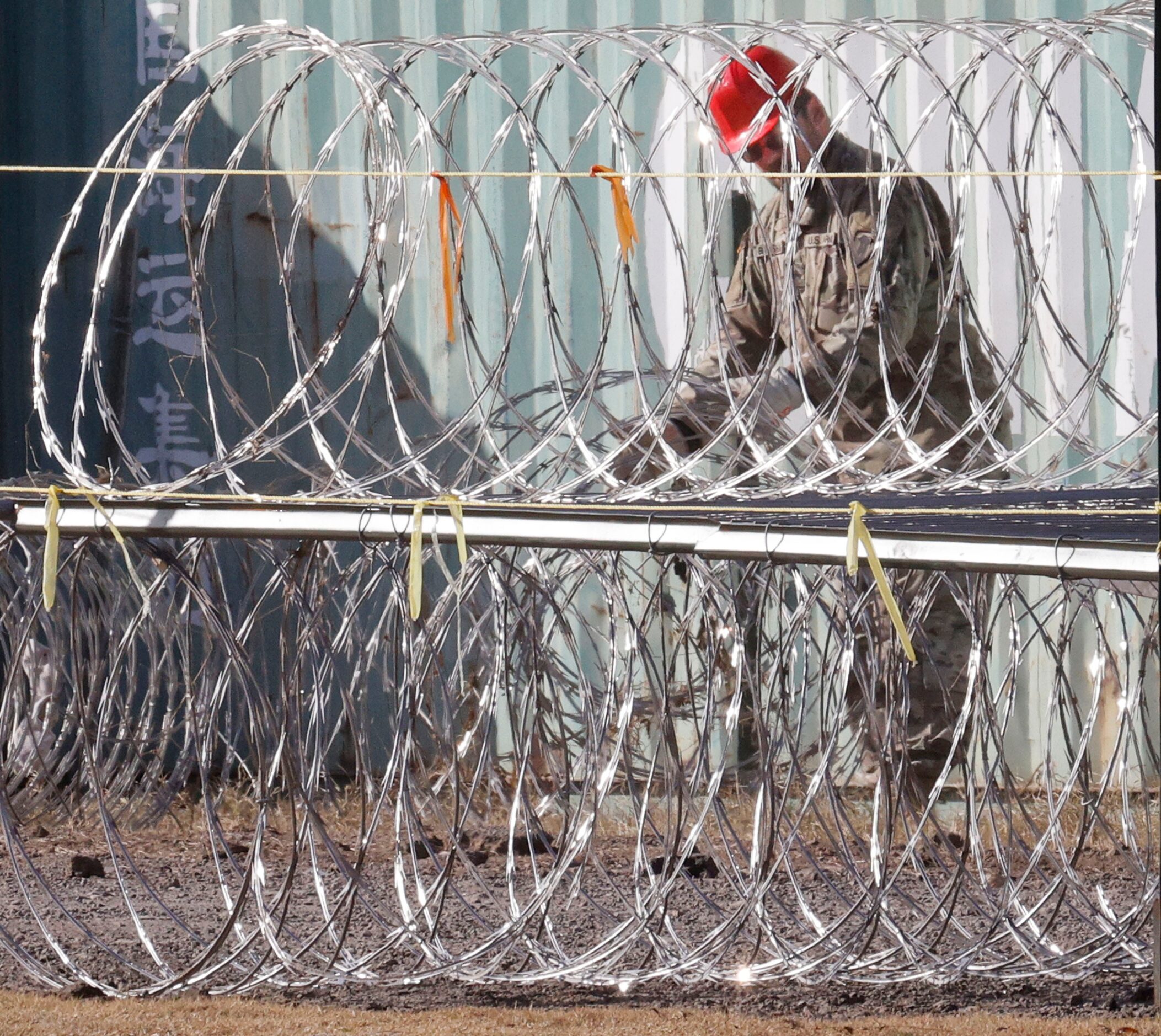 A National Guard soldier works on razor wire near Shelby Park, Wednesday, Jan. 31, 2024, in...