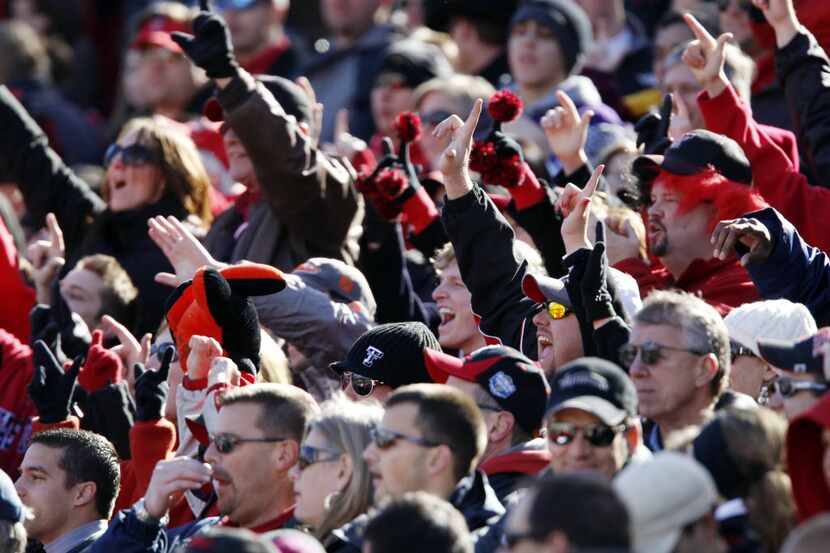 FILE - Texas Tech fans signal "Guns Up" after a Red Raider touchdown during the second...