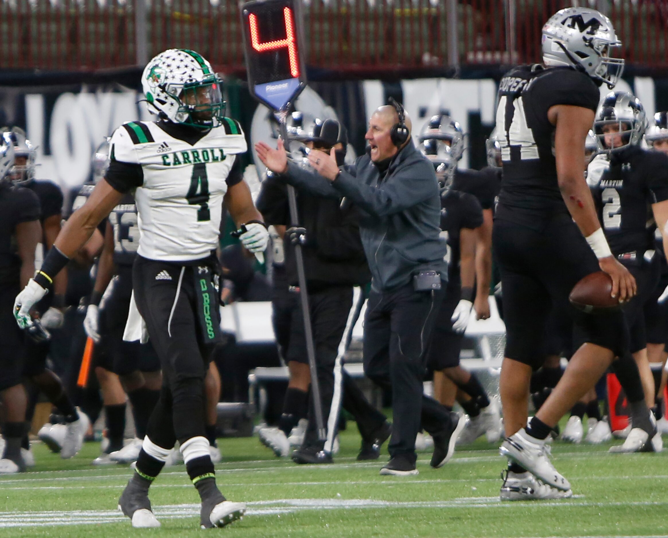 Arlington Martin head coach Bob Wager motivates his players on the team sideline during the...