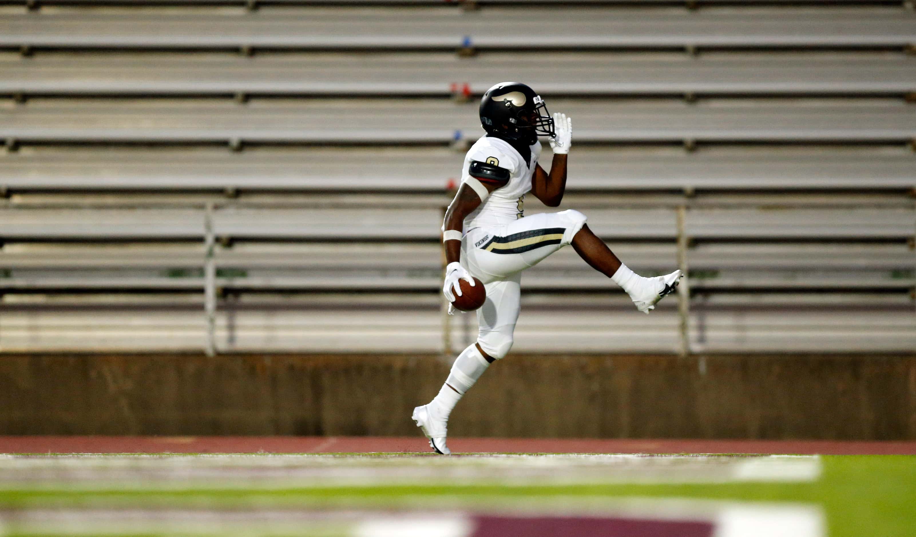 Pinkston running back Ronnie Cooper (9) high steps it through the end zone as he celebrates...