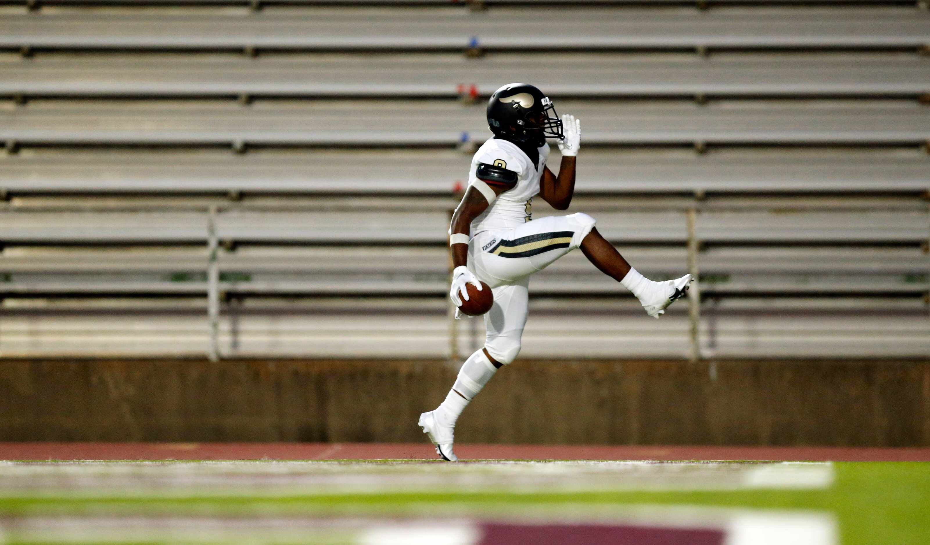 Pinkston running back Ronnie Cooper (9) high steps it through the end zone as he celebrates...