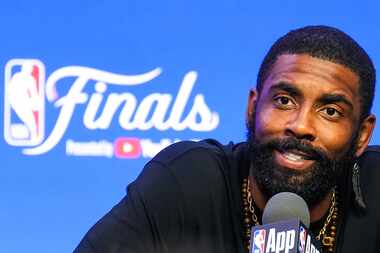 Dallas Mavericks guard Kyrie Irving addresses reporters during media day in preparation for...