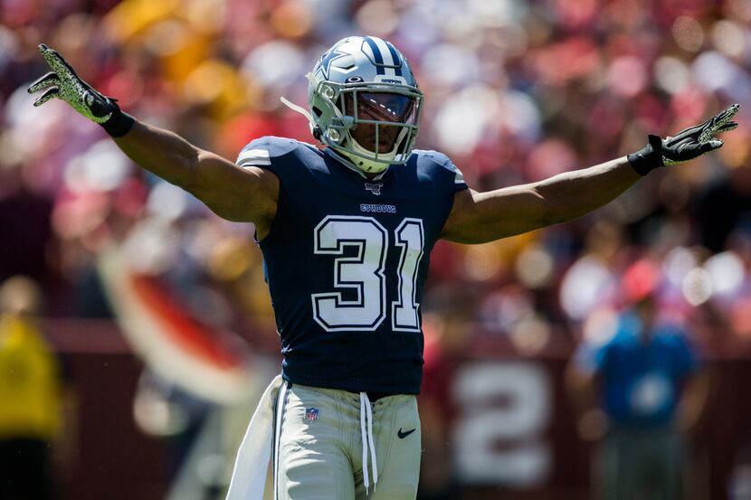 Dallas Cowboys cornerback Byron Jones (31) signals after he stops a pass during the first...