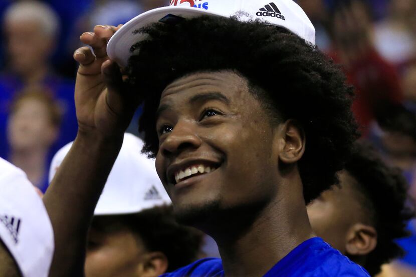 Kansas guard Josh Jackson dons his Big 12 championship hat following the team's NCAA college...