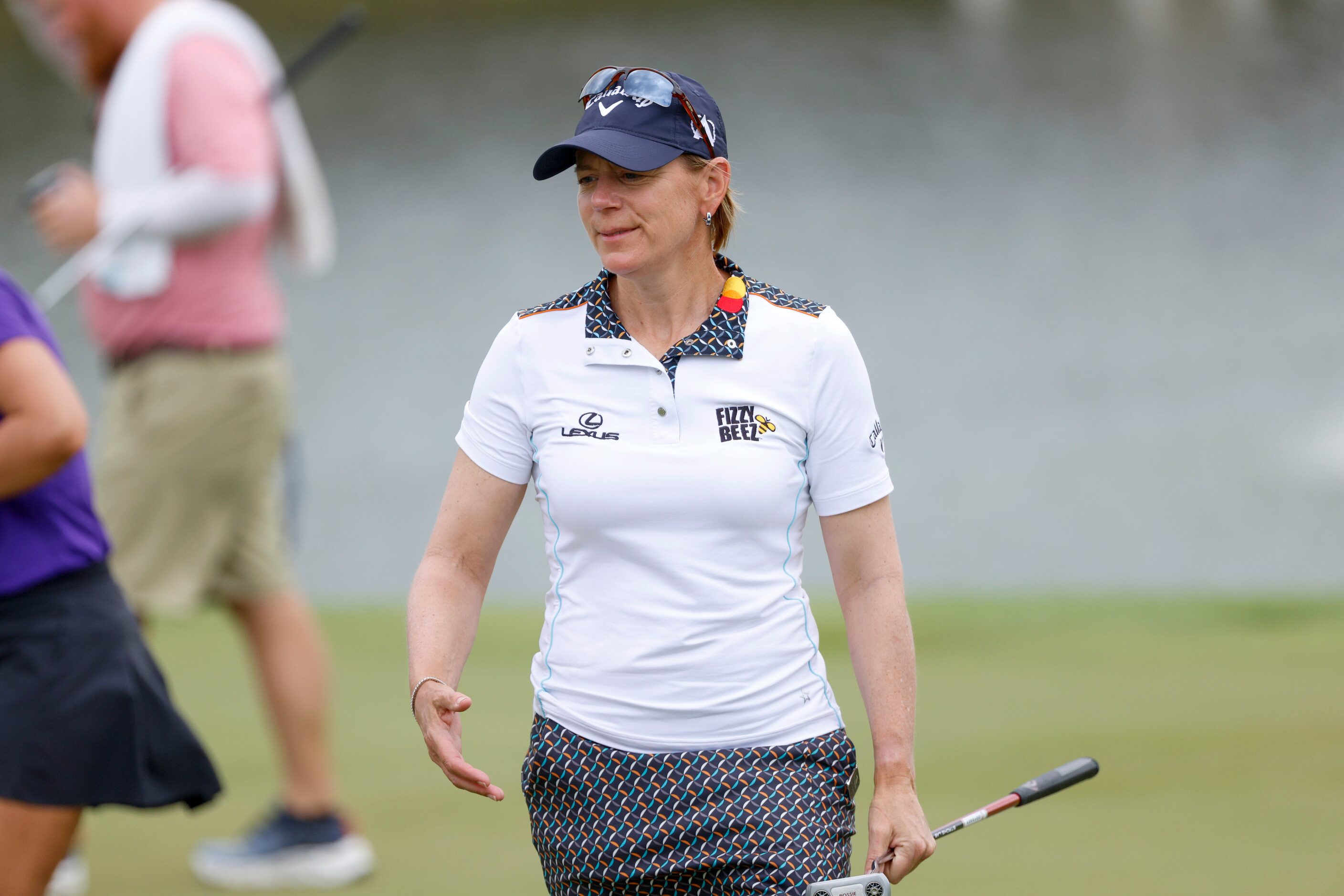 Professional golfer Annika Sorenstam greets a player after a finishing a round during the...