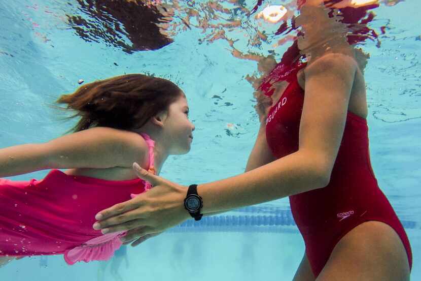  Ainsley Navin, 5, swam to lifeguard and swim instructor Amber Caldwell, 19, during a swim...