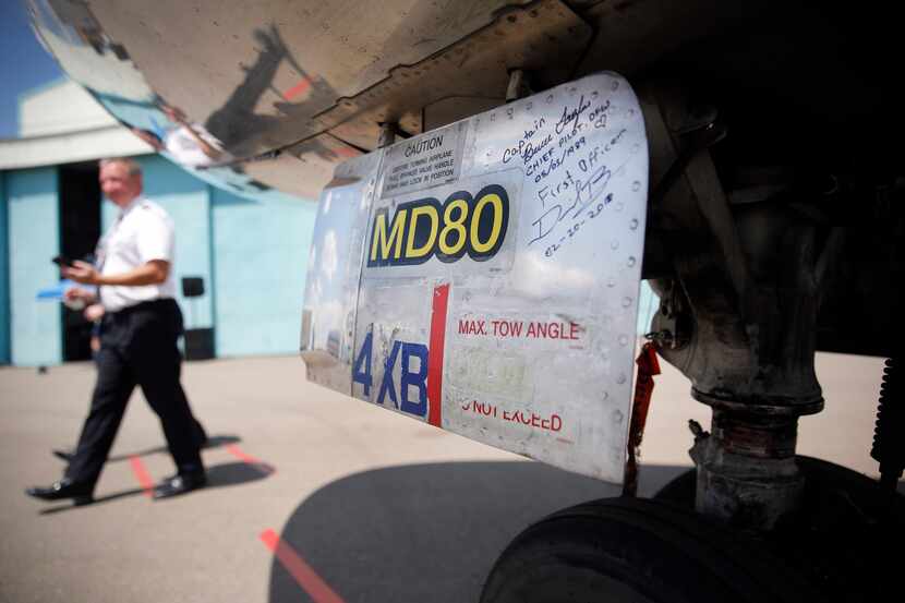 American Airlines pilots signed the nose wheel door after ferrying the MD-80 to Roswell...