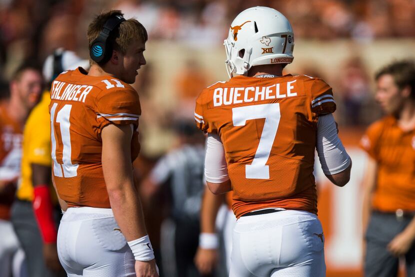 Texas Longhorns quarterback Sam Ehlinger (11) talks to quarterback Shane Buechele (7) on the...