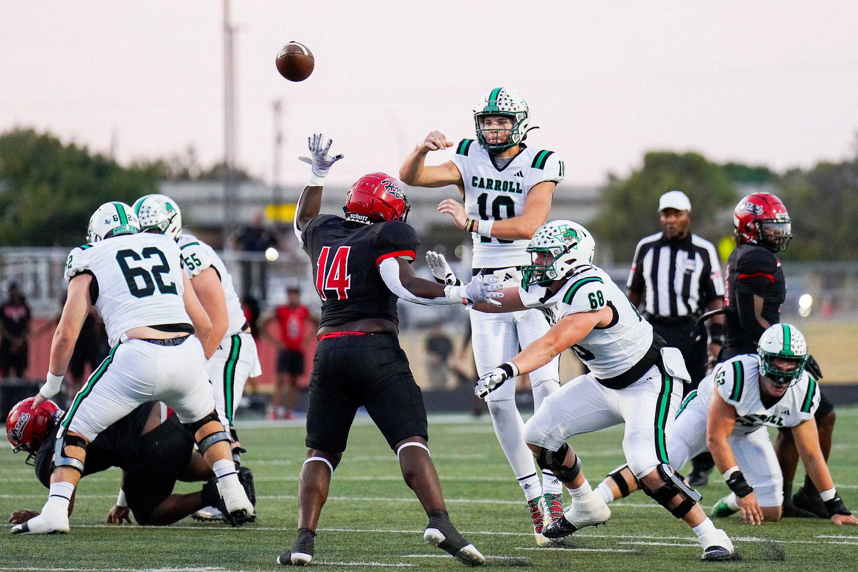 Southlake Carroll quarterback Graham Knowles (10) throws a pass over Cedar Hill linebacker...