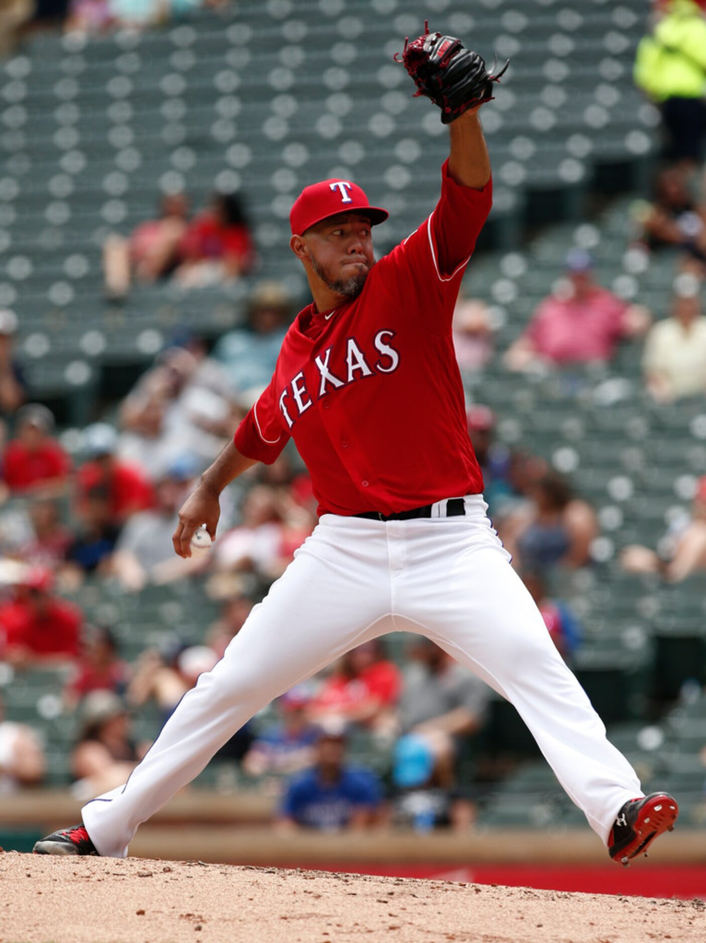 Texas Rangers starting pitcher Yovani Gallardo delivers against the Seattle Mariners during...