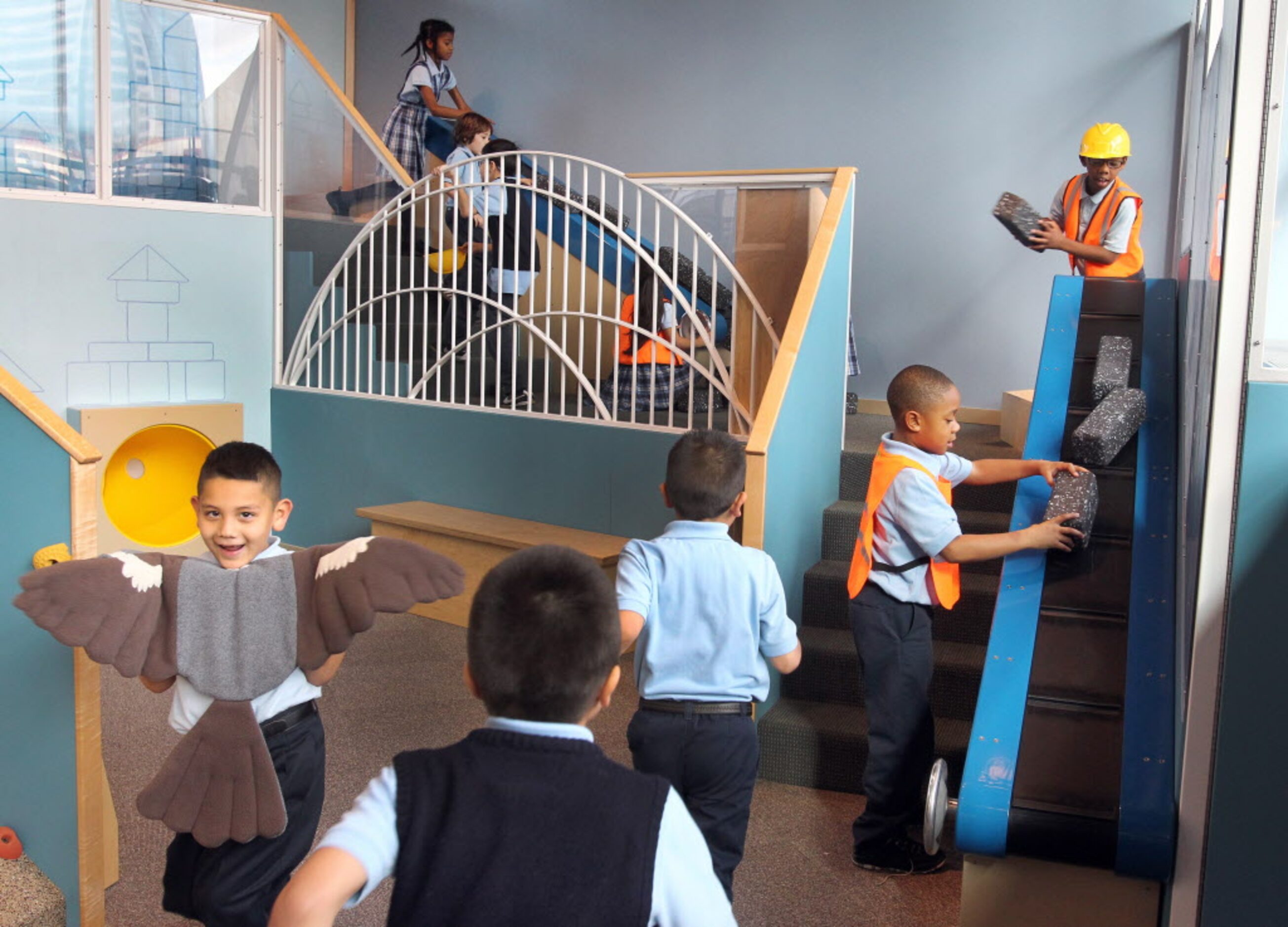 Kids play in the Dallas Skyline Climber on the lower level at the Perot Museum of Nature and...