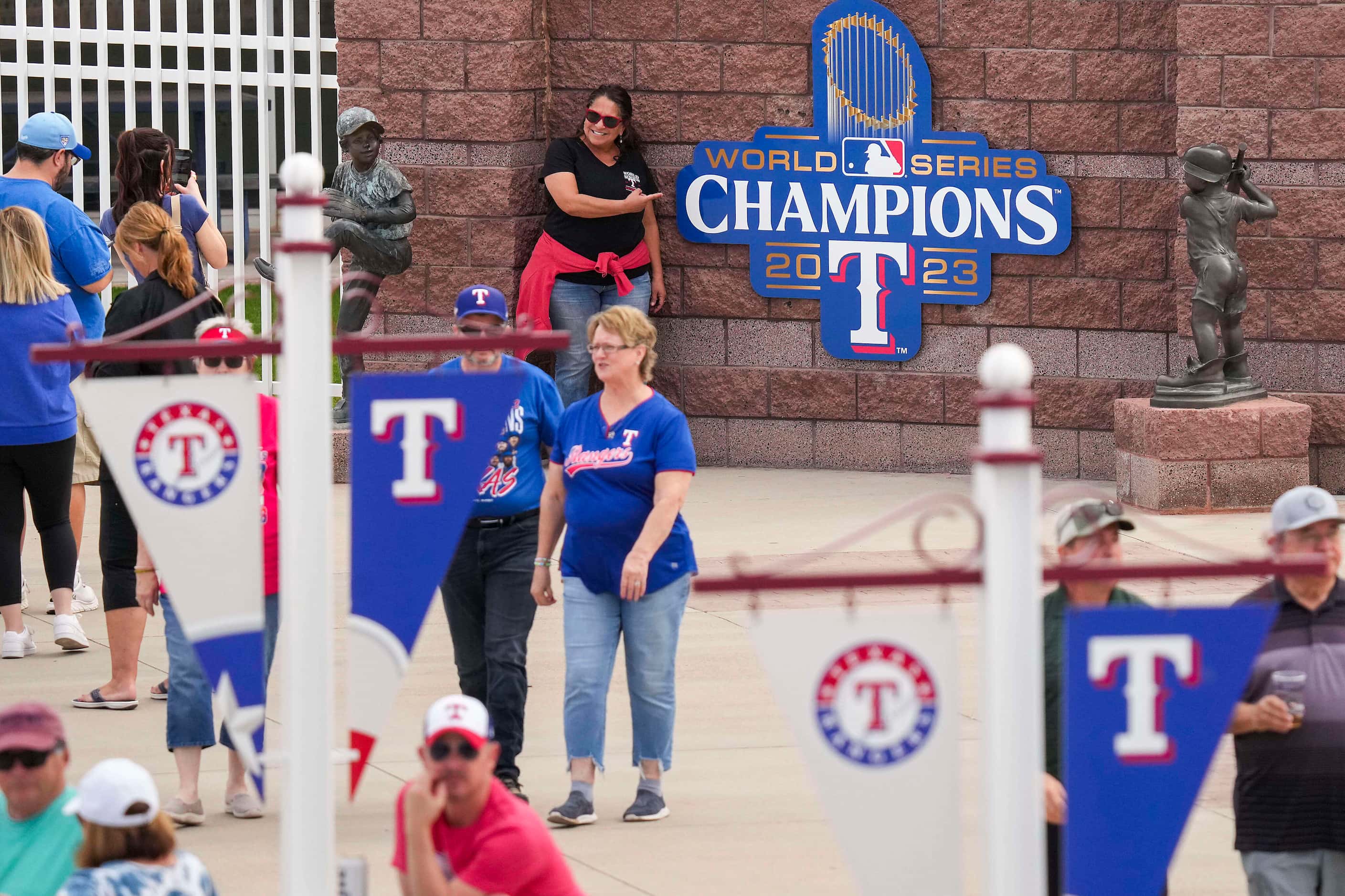 Fans pose for photos with a logo commemorating the Texas Rangers 2023 World Series...