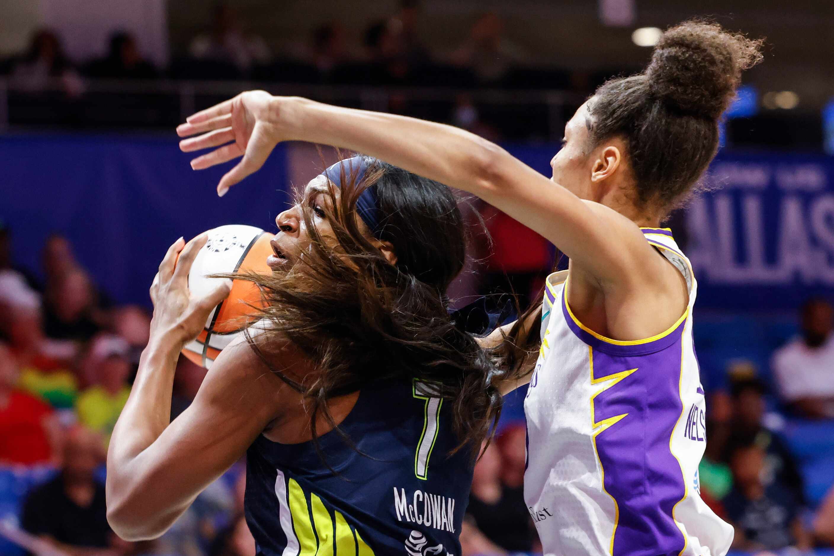 Dallas Wings center Teaira McCowan, left, attempts to drive to the basket as Los Angeles...