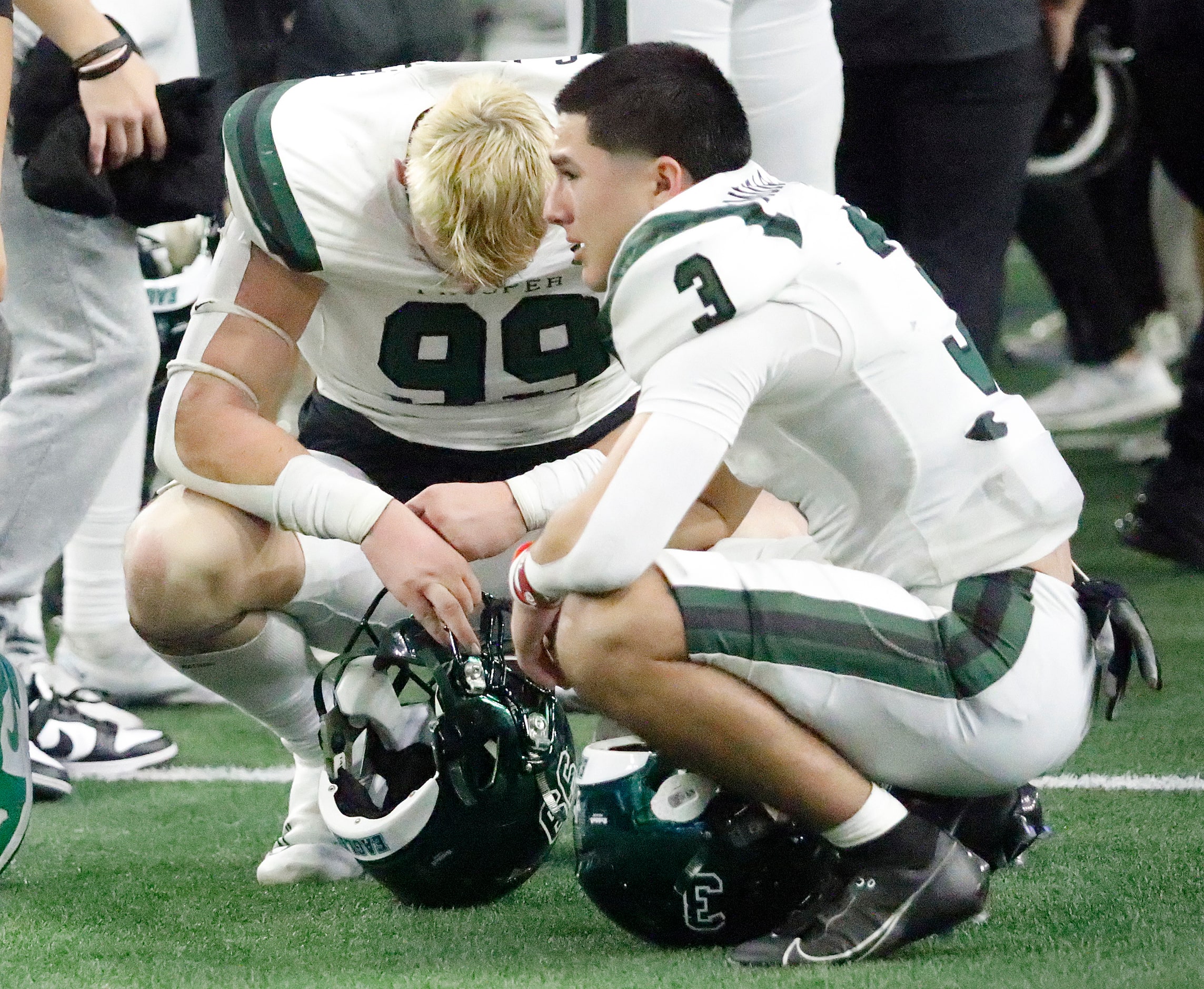 Prosper High School’s Chase Mercer (99) and Prosper High School’s Bo Mongaras (3) reflect...