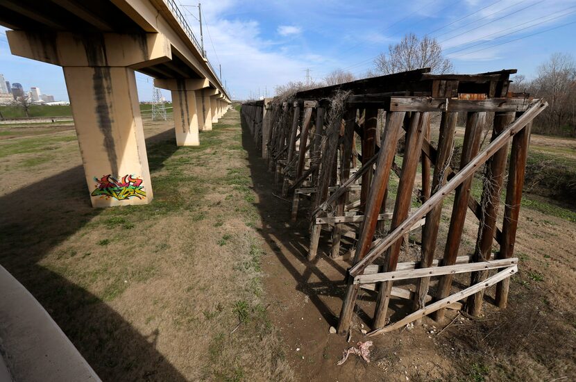 The DART train bridge (left) parallels the old Atchison Topeka & Santa Fe (AT&SF) trestle in...