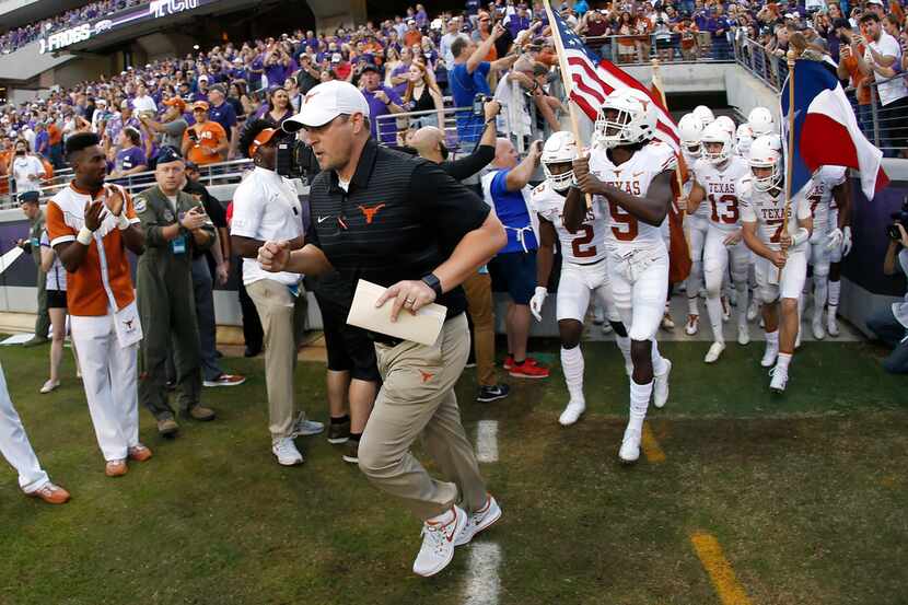 Texas coach Tom Herman takes the field with his team before an NCAA college football game...