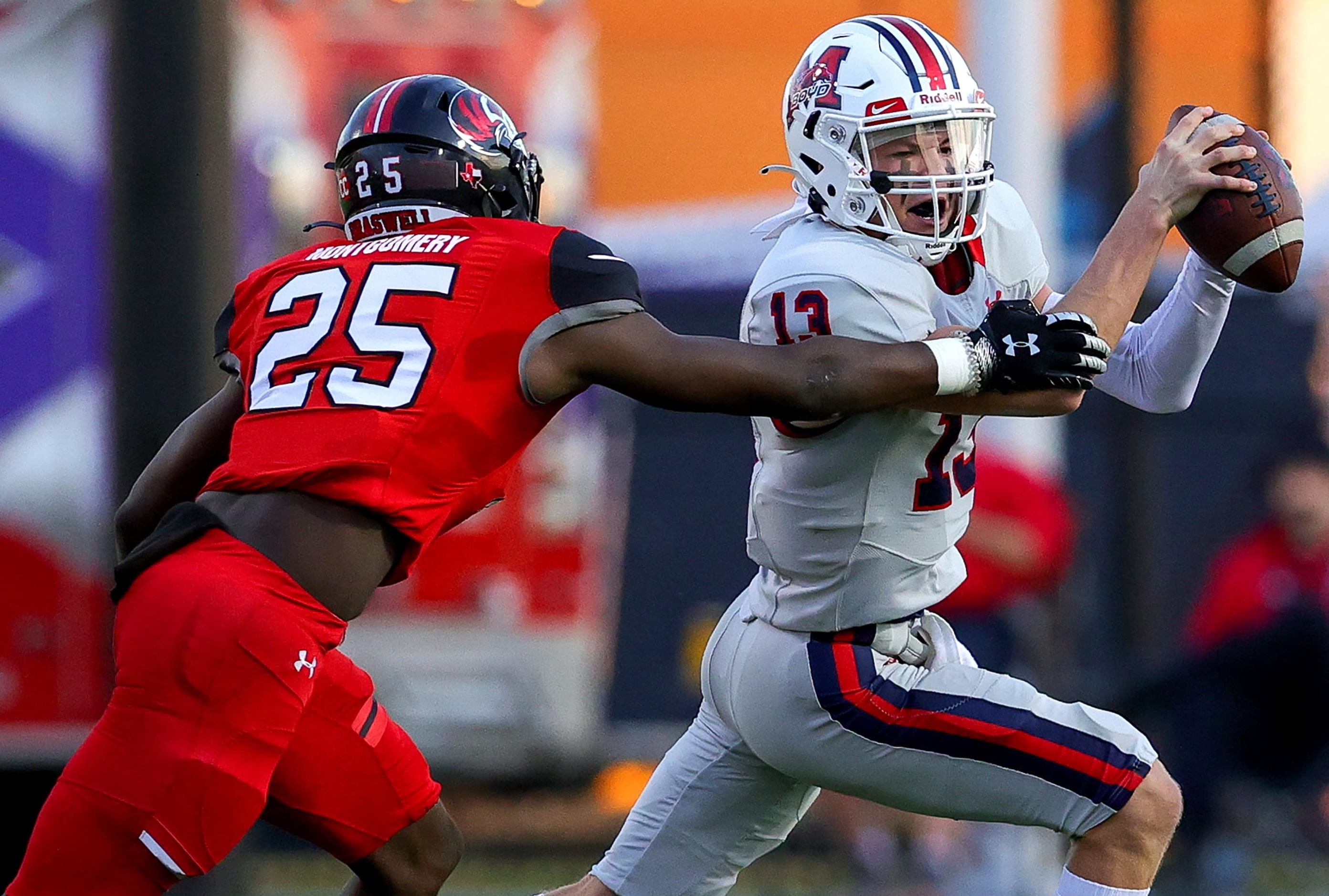 McKinney Boyd quarterback Ryan Shackleton (13) tries to scramble past Denton Braswell...