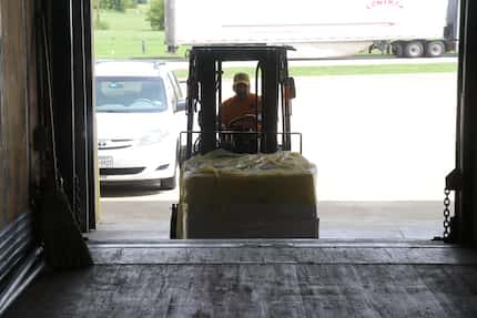 Russell Schieck loads a truck with supplies. 