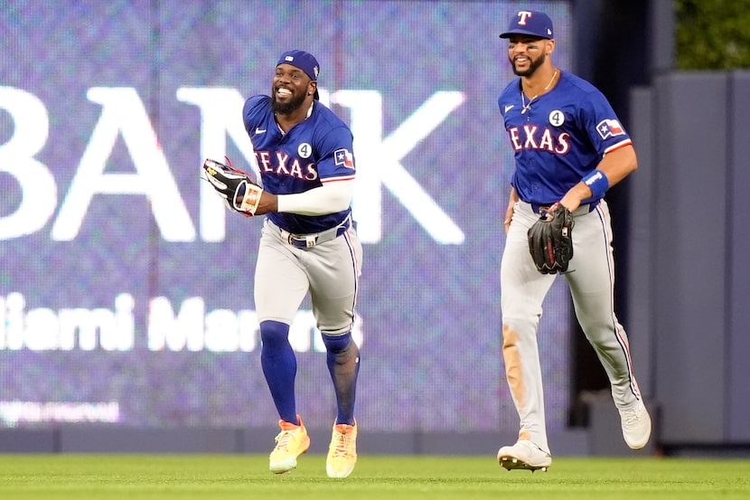 Texas Rangers right fielder Adolis Garcia, left, and center fielder Leody Taveras, celebrate...