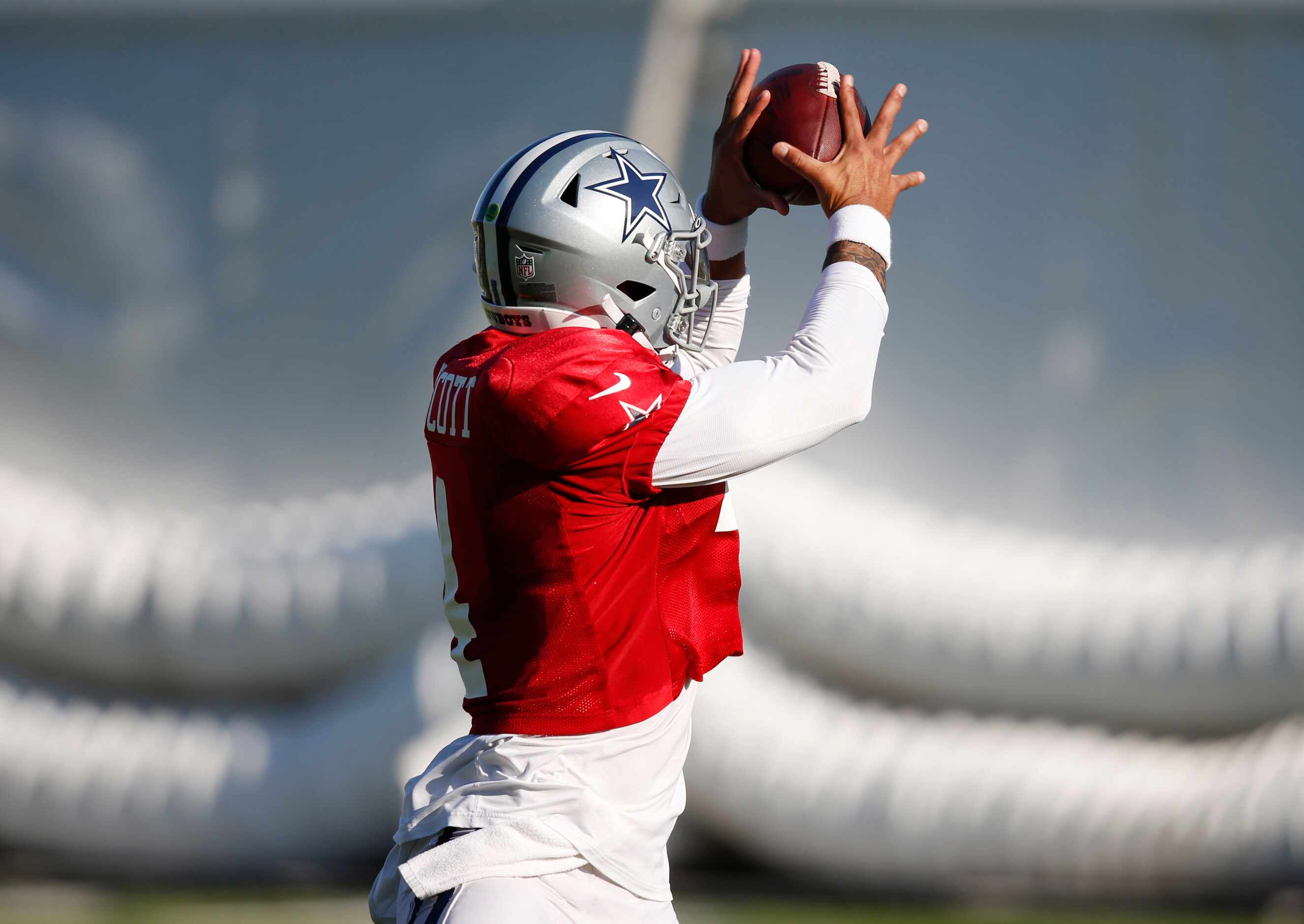 Dallas Cowboys quarterback Dak Prescott (4) catches a pass in practice during training camp...